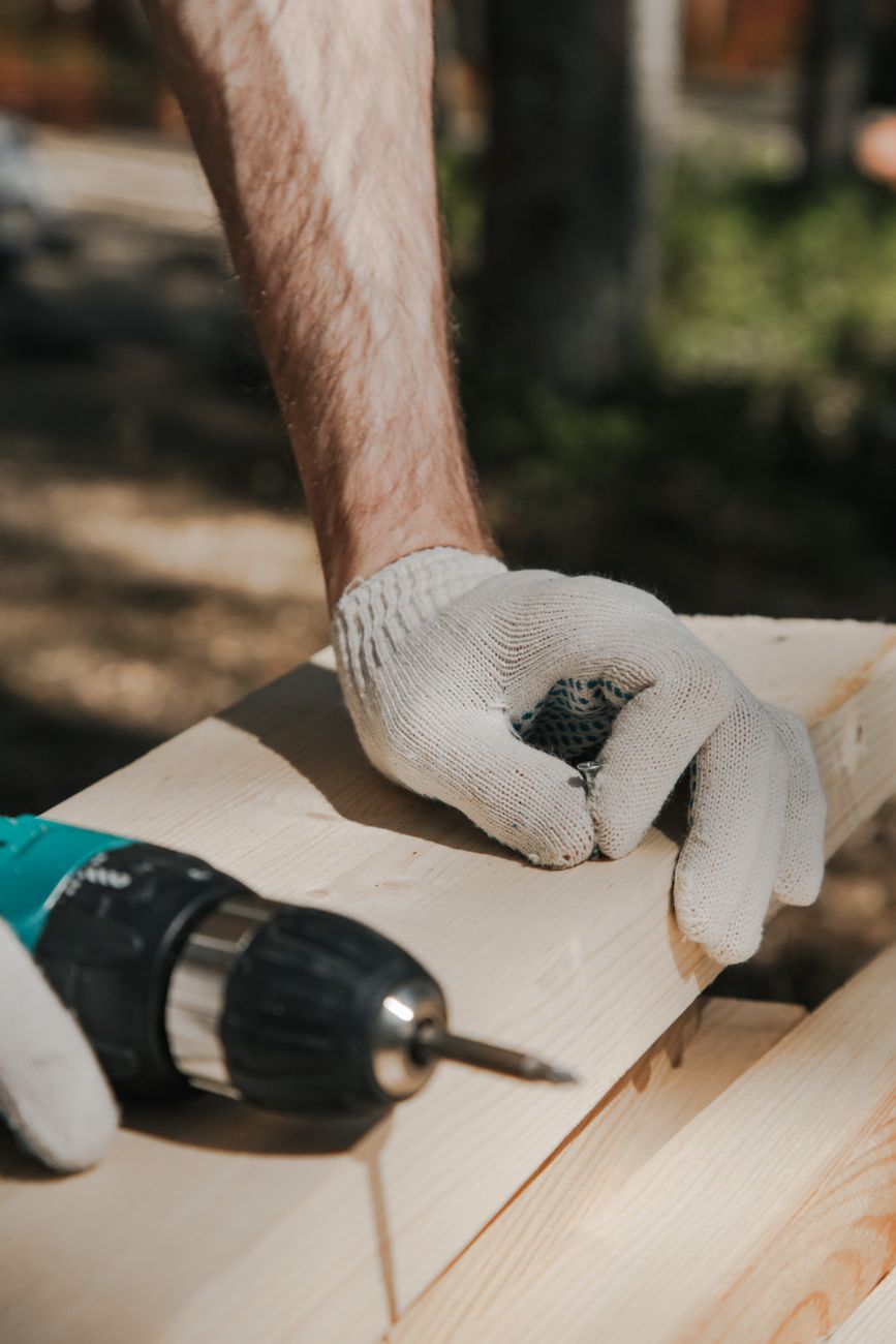 Fencing craftspeople carefully constructing heavy timber boundaries